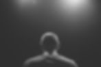 man from behind in dark room