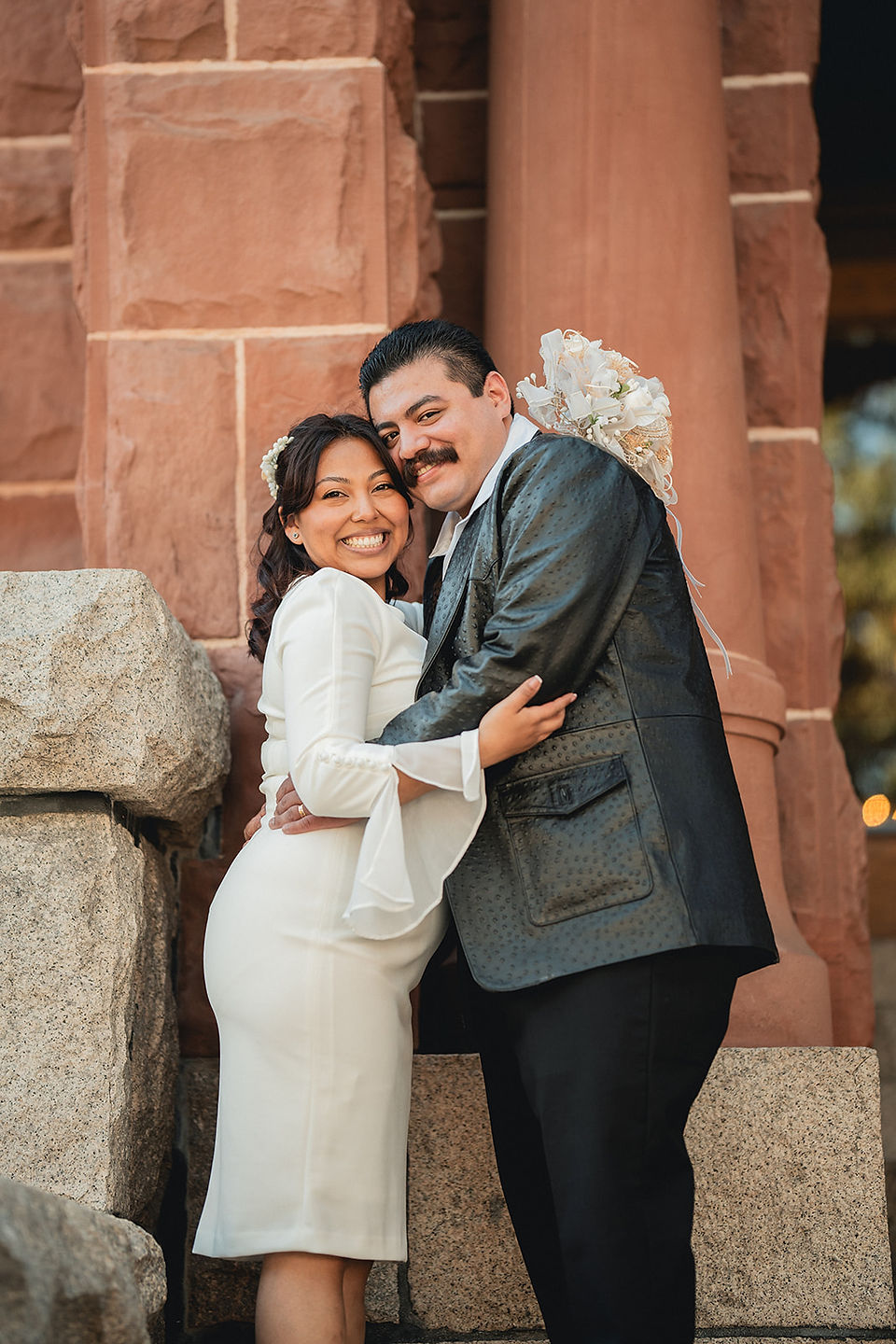 Newly weds hugging after their elopement ceremony at Old Orange County Courthouse shot by Paper Birch Collective, California Wedding Photographer and Videographer Team in Orange County