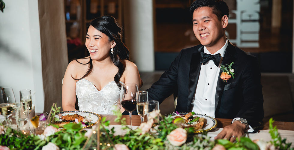 Newly weds laughing at speech during reception at Villa and Vine in Santa Barbara shot by Alvis Pham Photography, Orange County California Wedding Photographer