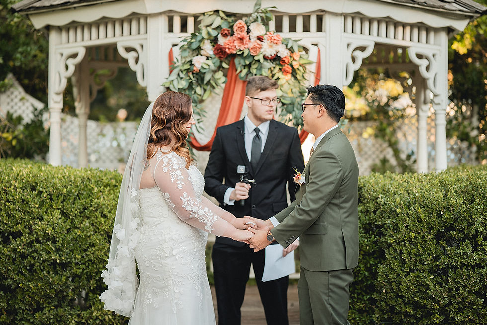 Bride and groom hold hands during ceremony at Edwards Mansion shot by Paper Birch Collective, California Wedding Photographer and Videographer Team in Orange County