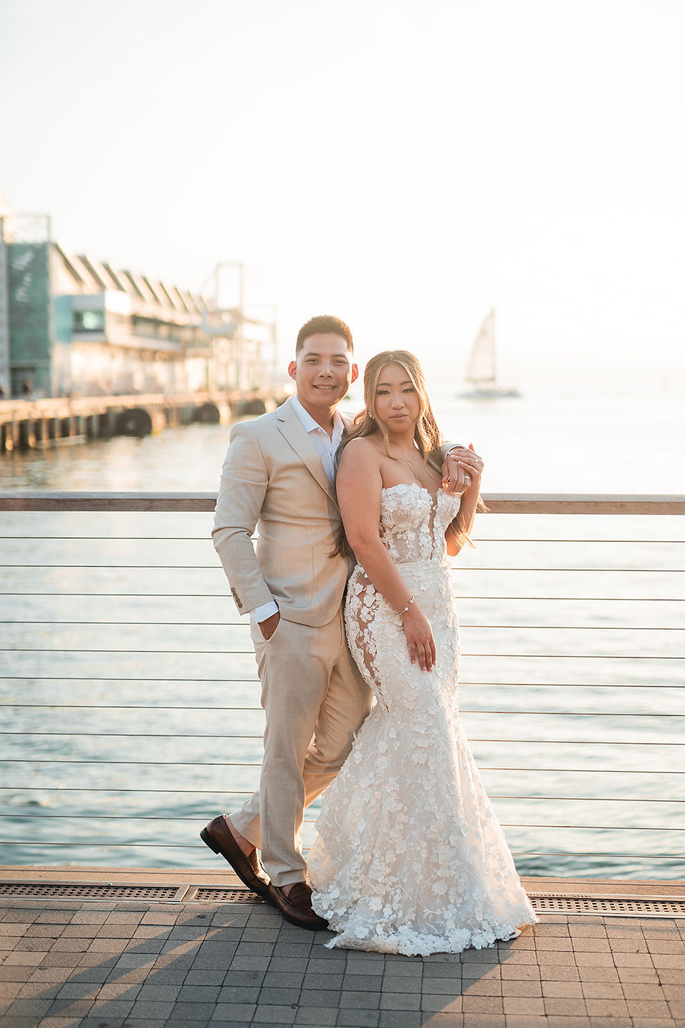 Bride and groom on the pier at sunset during reception at The Lane in San Diego photographed by Alvis Pham Photography, Orange County California Award-winning Wedding Photographer