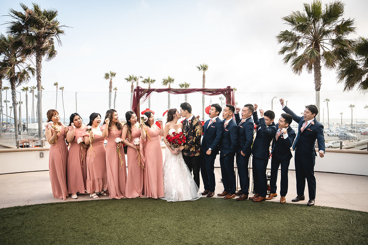 Newly weds with wedding party at The Waterfront Beach Resort shot by Paper Birch Collective, California Wedding Photographer and Videographer Team in Orange County