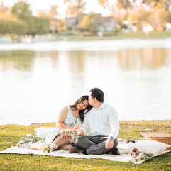 Couple sitting in park for picnic after proposal shot by Paper Birch Collective, California Wedding Photographer and Videographer Team in Orange County