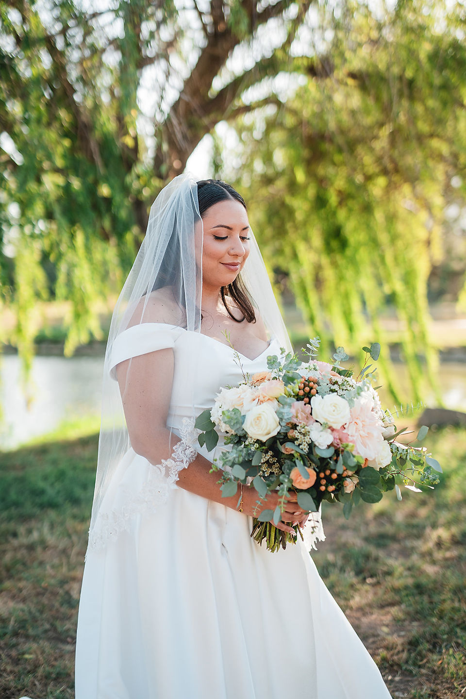 Bride with bouquet solo photoshoot by a willow tree shot by Alvis Pham Photography, Orange County California Wedding Photographer, at Sierra La Verne by Wedgewood Weddings