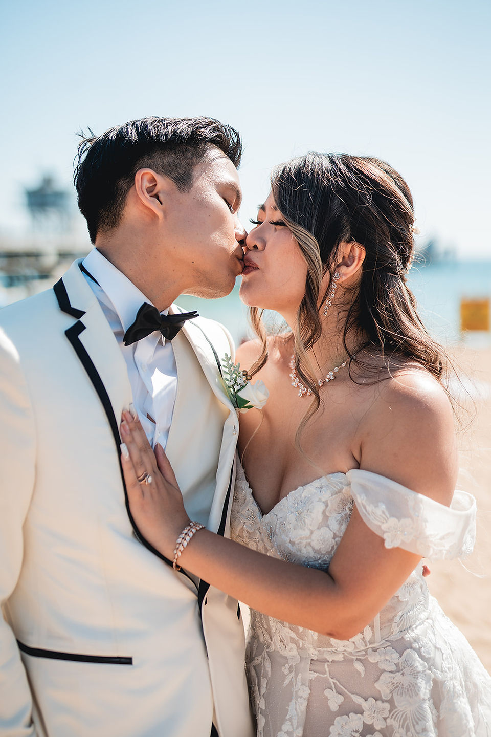 Newly weds kiss at the beach after the ceremony at Grey Museum shot by Alvis Pham Photography, Orange County California Wedding Photographer
