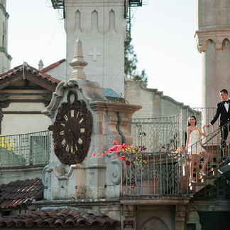 Couple hold hands on staircase at The Mission Inn Hotel for engagement photoshoot by Paper Birch Collective, California Wedding Photographer in Orange County