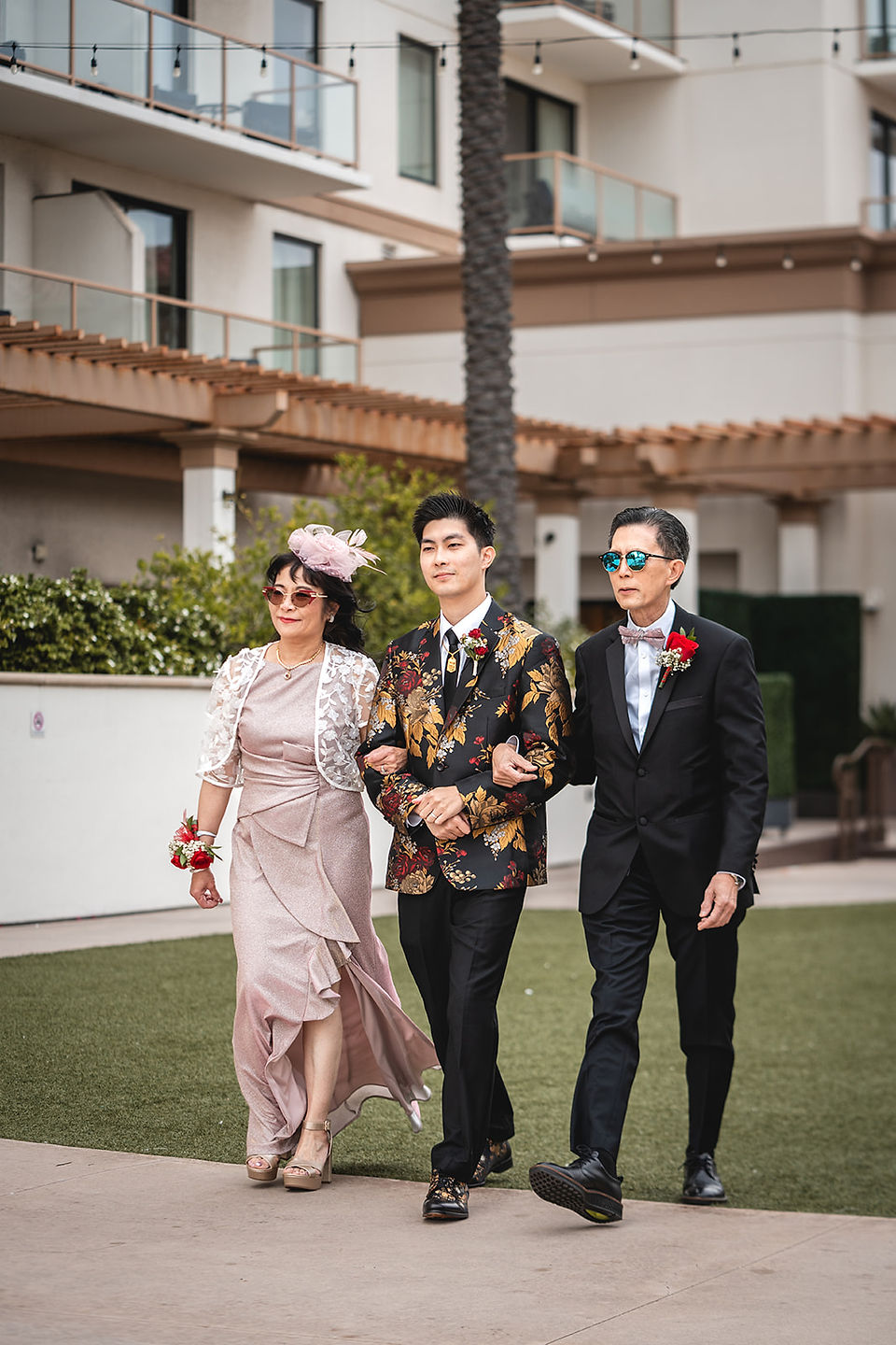 Groom walks down aisle with parents at The Waterfront Beach Resort shot by Paper Birch Collective, California Wedding Photographer and Videographer Team in Orange County