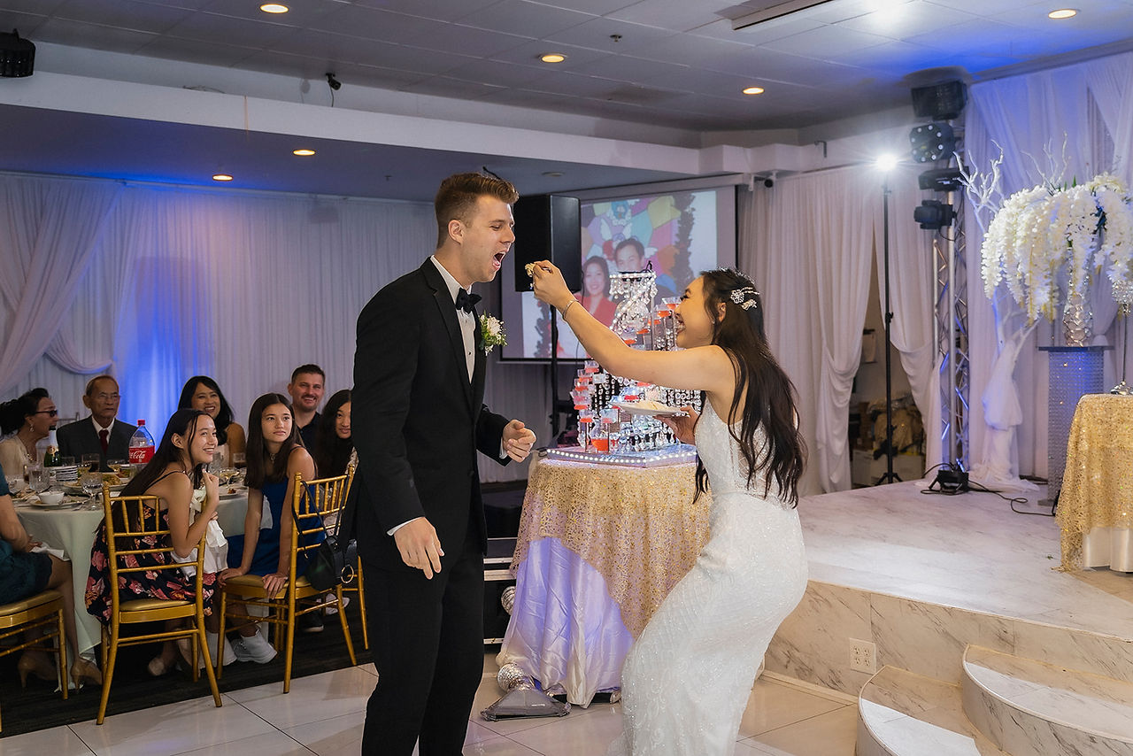 Groom eats cake from bride at Wedding reception shot by Paper Birch Collective, California Wedding Photographer in Orange County