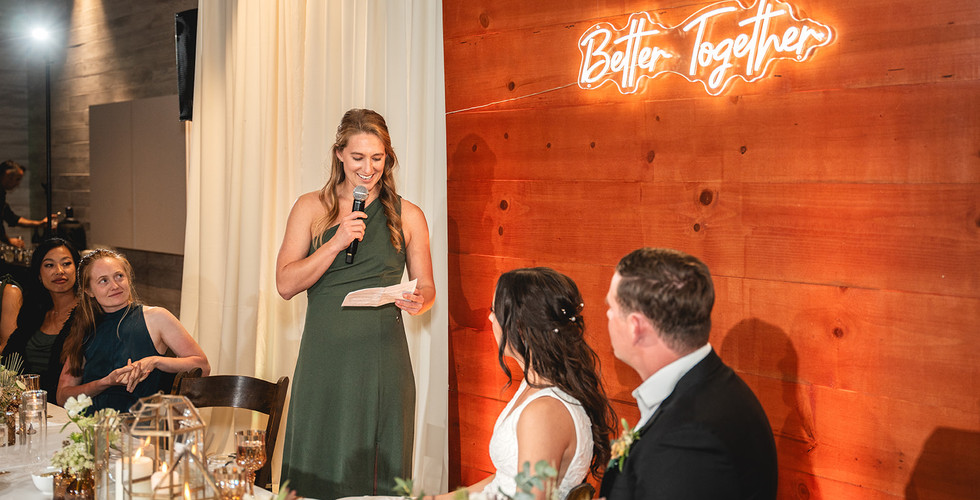 Newly weds during the speeches at The Barn at Aliso Viejo Ranch reception by Paper Birch Collective, California Wedding Photographer in Orange County