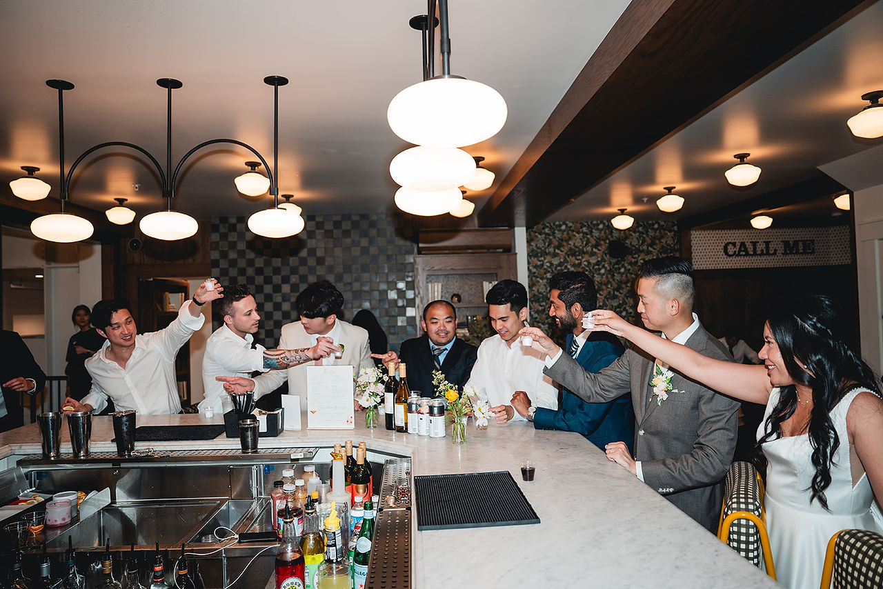 Cheers at the bar at The Richland photo by Alvis Pham Photography, Orange County California Wedding Photographer