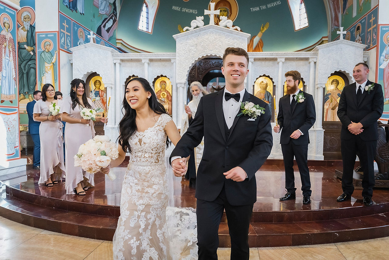 Bride and groom walk down aisle after wedding church ceremony shot by Paper Birch Collective, California Wedding Photographer in Orange County