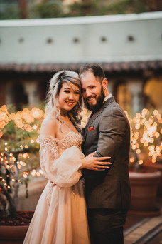 Couple outside at night at Mission Inn Hotel for engagement shot by Paper Birch Collective, California Wedding Photographer and Videographer Team in Orange County