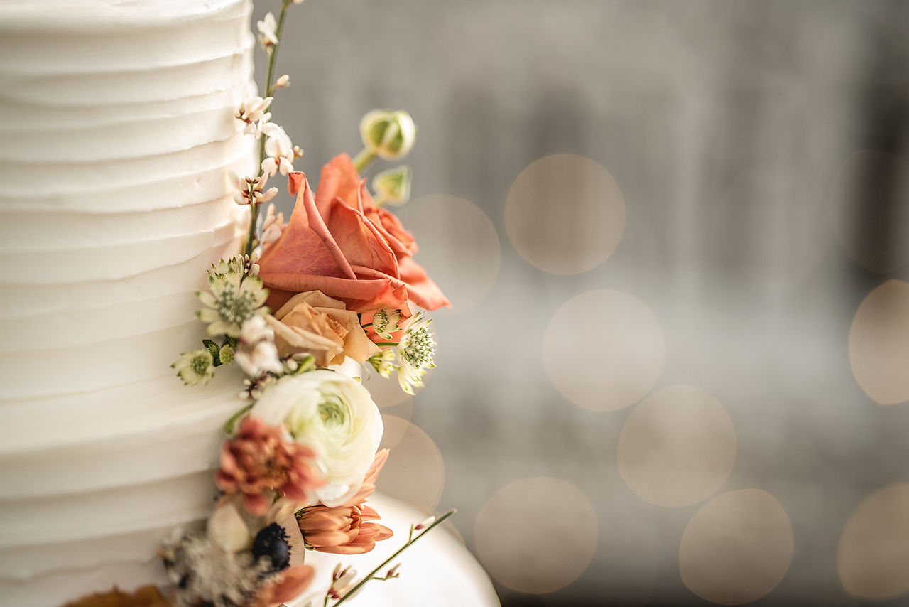 Socal Beach Wedding Reception cake florals detail photo at Occasions in Laguna Beach taken by Paper Birch Collective, California Wedding Photographer in Orange County