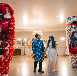 Bride and Groom hold hands at the wedding reception with lion dancers shot at The Harper in Costa Mesa by Alvis Pham Photography, Orange County California Wedding Photographer