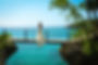 bride on a bridge connecting two cliffs overlooking the Caribbean ocean
