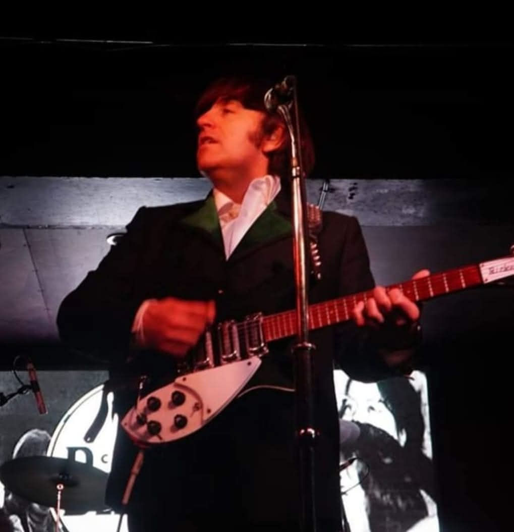 Jimmy Coburn playing electric guitar on stage