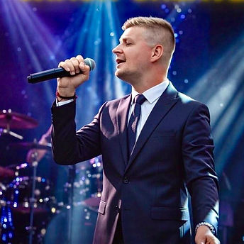 A male singer on an independent artist roster performing.