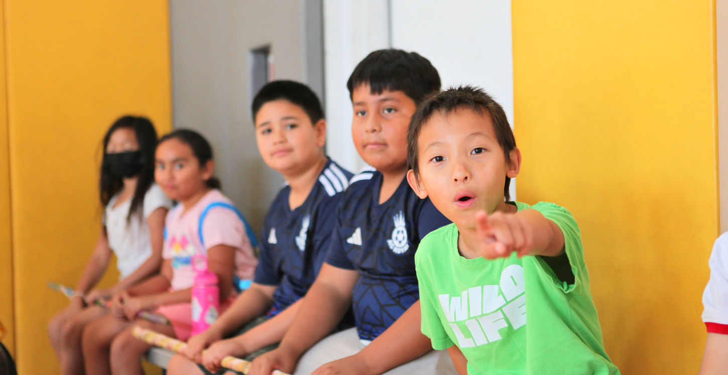 DDKC youth sitting together with their spirit stick.