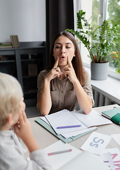 young-woman-doing-speech-therapy-with-little-boy.jpg