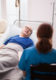 back-view-nurse-sitting-chair-talking-with-pensioner-nursing-home.jpg