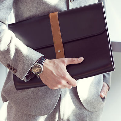 Businessman holding briefcase, close up