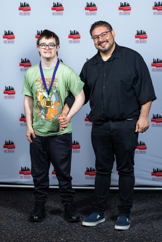 At Joy House Film Festival. One wears a Jungle Book t-shirt and medal. Joyful mood,