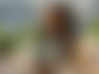 woman reading a book on a balcony