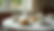 Eye-level view of a beautifully set tea table with fine china and scones
