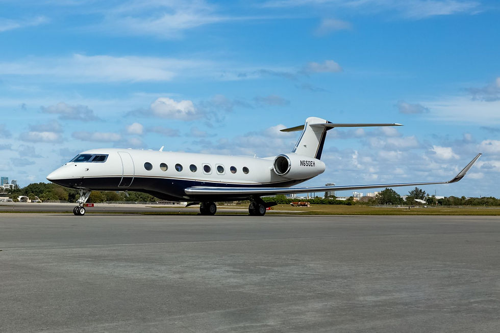 White and navy private jet on a runway in France.