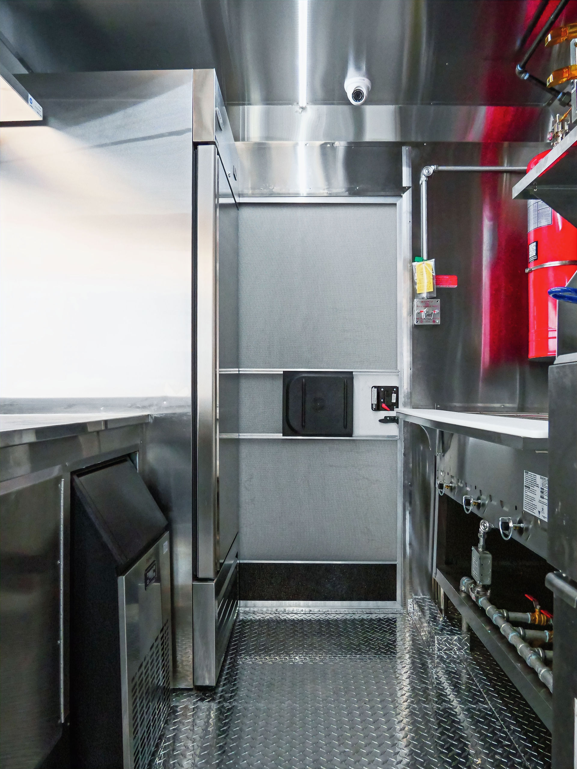 Interior view of refrigeration and prep zone inside Curry and Grill truck