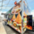 Full angled view of The Flame Indian Kitchen trailer with full wrap