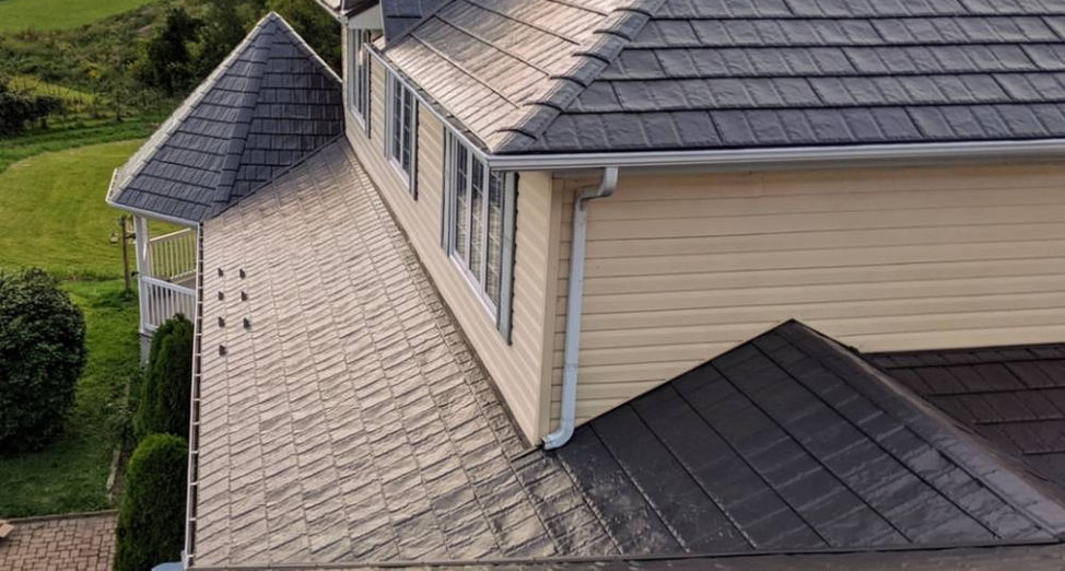 A beautiful suburban home featuring a newly installed durable steel roof with a modern shingle design, completed by Premium Roofing.