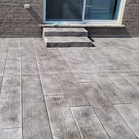 Wood-look stamped concrete patio with steps.