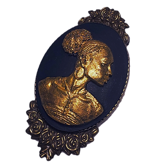 A beautiful black and brass afro black lady cameo brooch in a antique brass setting that is embroidered with flowers.