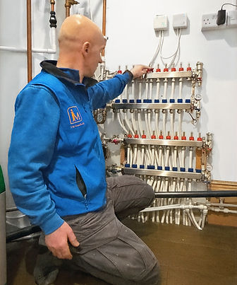 Plumber fixing a boiler in a residential home
