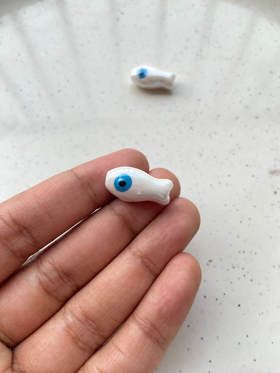 Thumbnail: Porcelain fish bead, vertically drilled