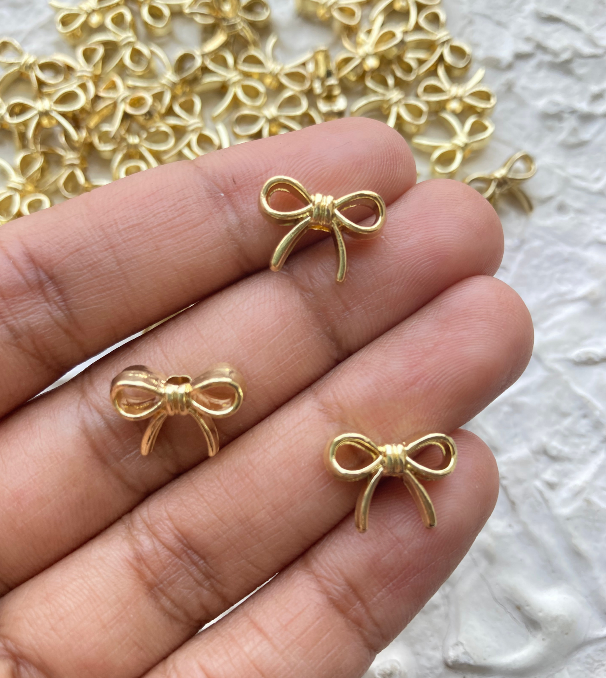 Alloy golden bow bead, vertically drilled