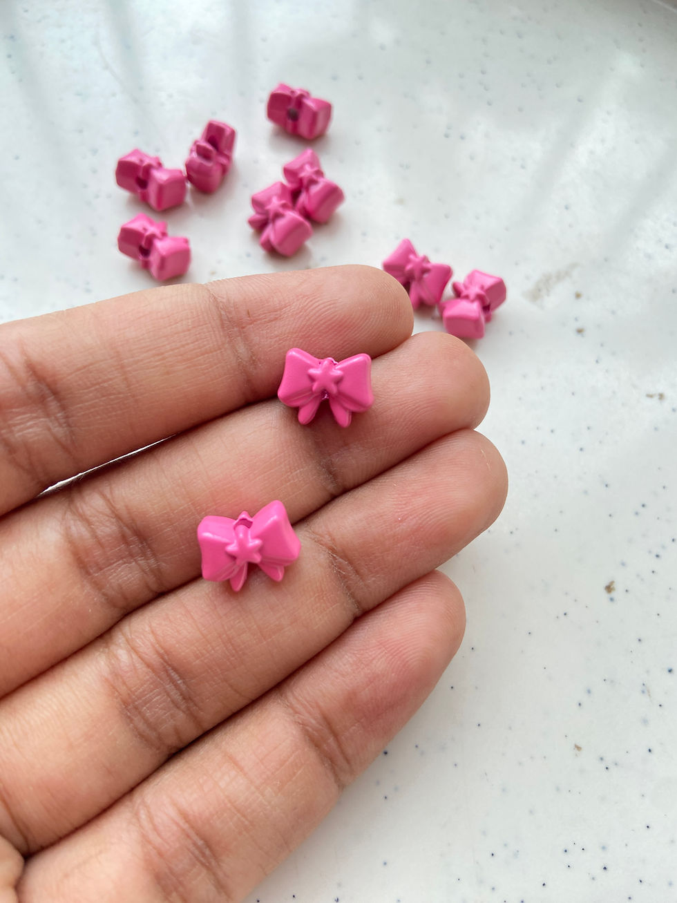 Thumbnail: Spray painted bow alloy bead, vertically drilled
