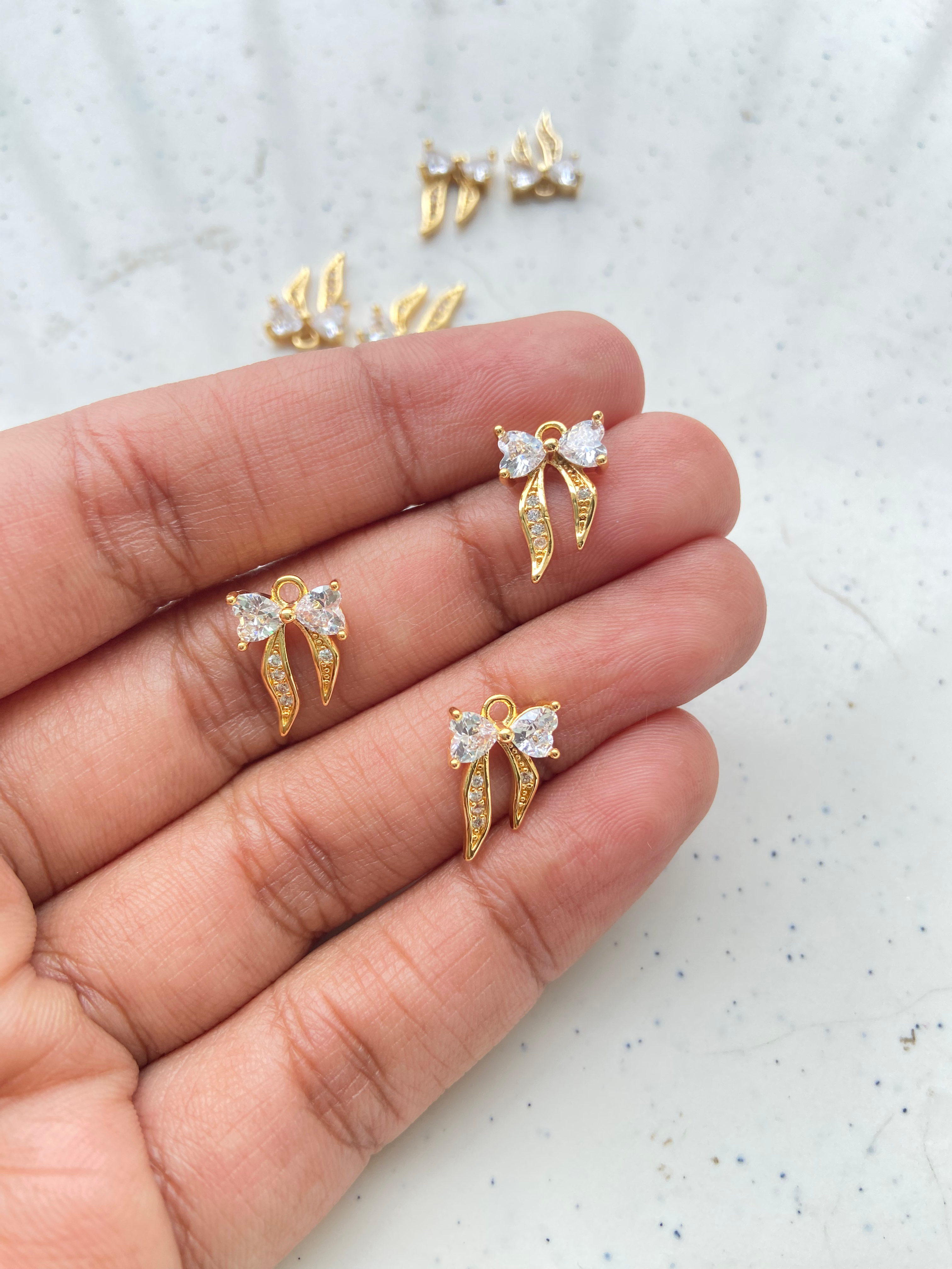 Tiny bow with heart shape zircon charm