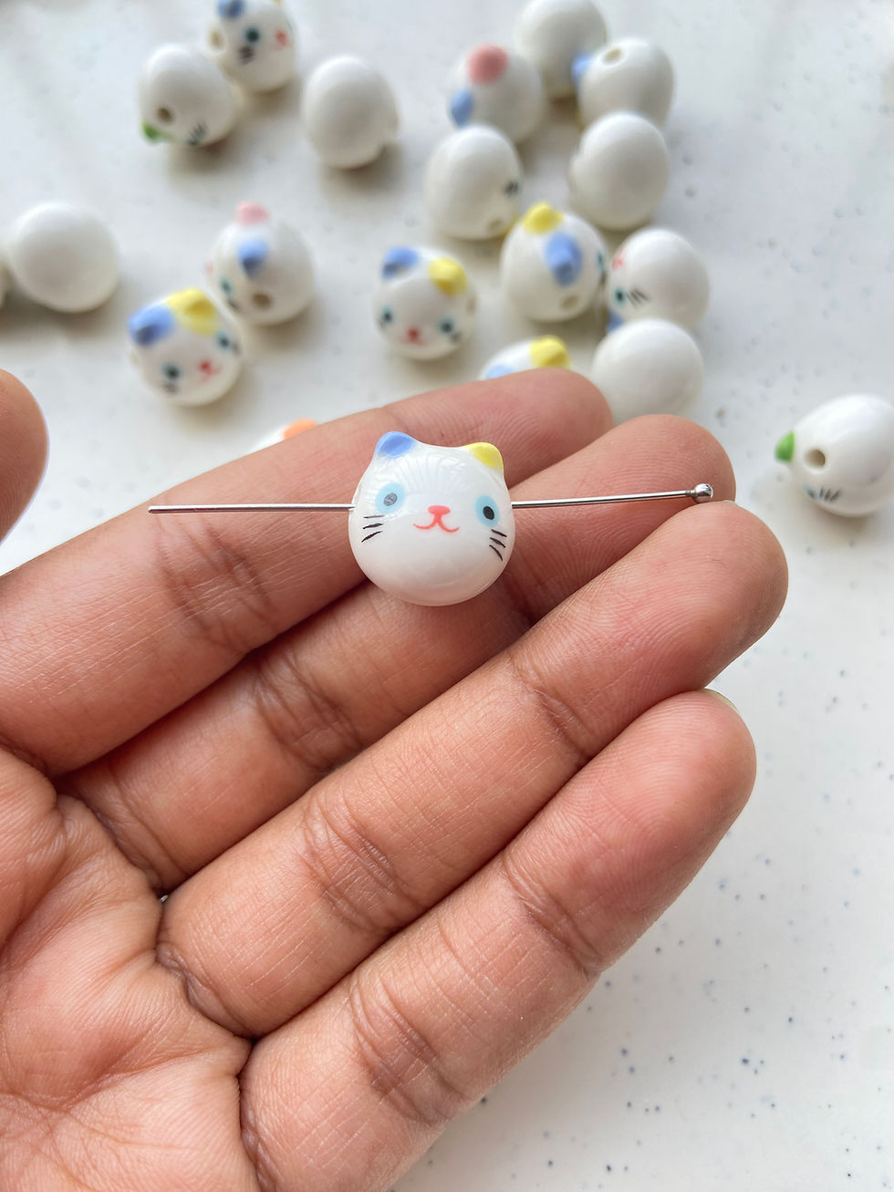 Thumbnail: Porcelain cat face bead, horizontally drilled