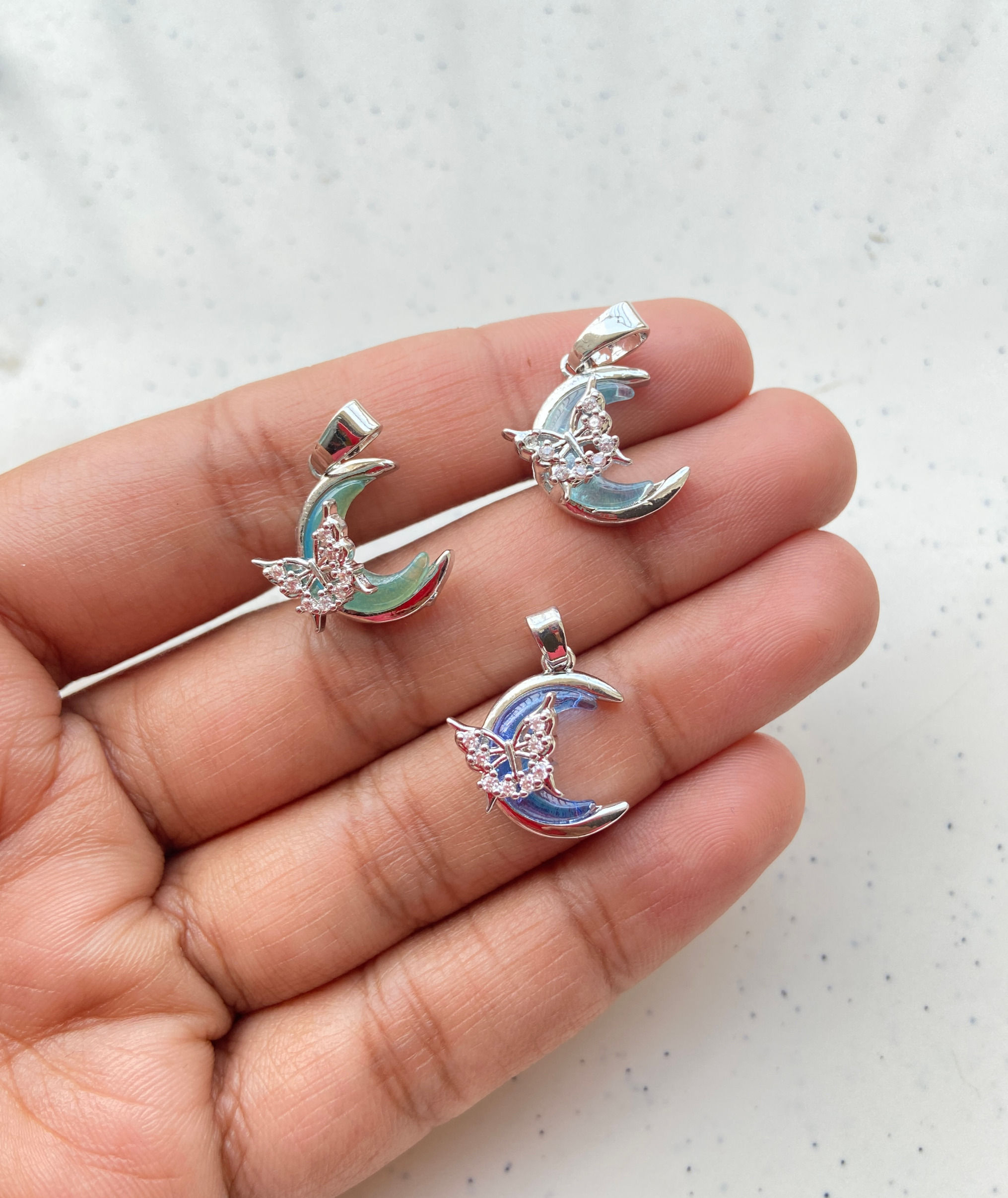 Platinum plated, zircon moon with butterfly charm