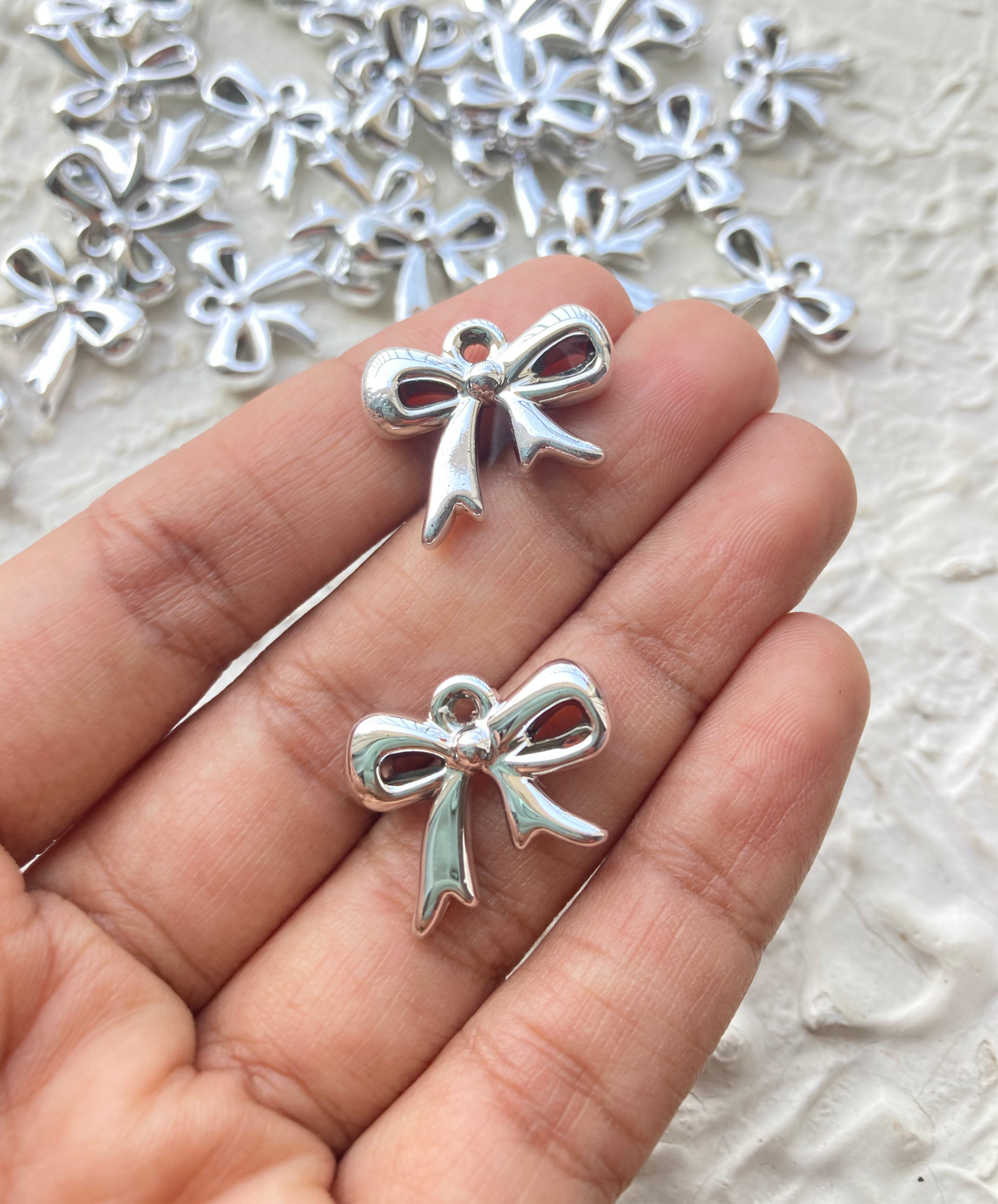 Silver plastic bow charm