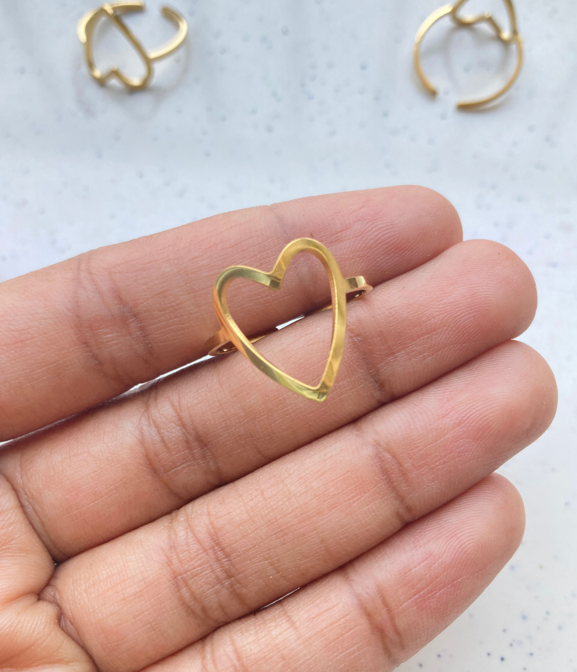 Elongated hollow heart bezel adjustable ring