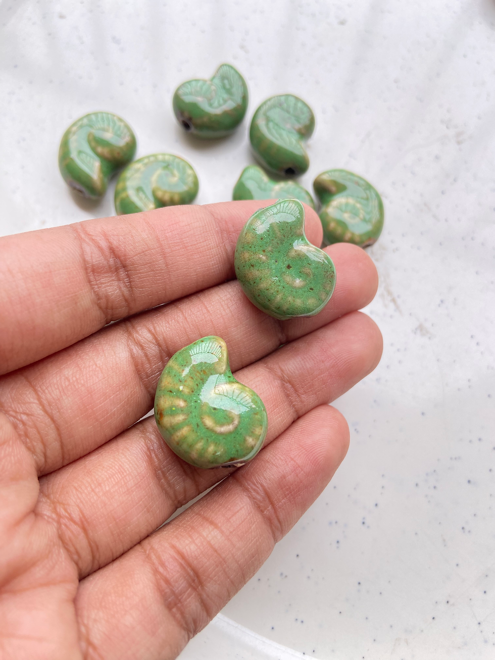 Thumbnail: Spiral shell shape porcelain bead, vertically drilled