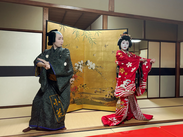 Two geishas performing, one dressed as a male and the other is the female geisha