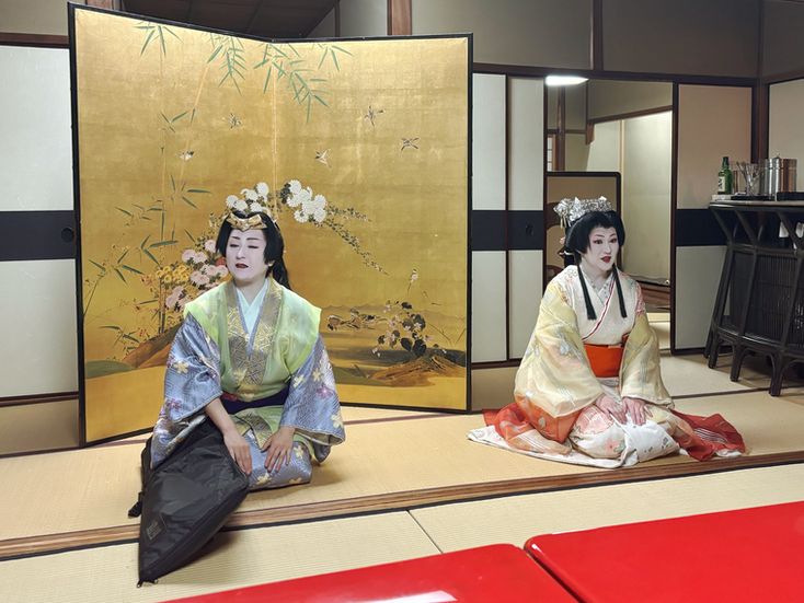 Two geishas sitting down