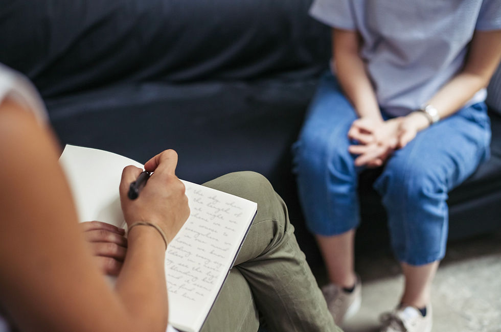 Person sitting in a therapist’s office, engaged in a supportive counseling session, with a calm and welcoming atmosphere.