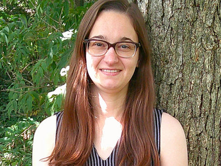 Portrait of Lauren Eberle, Licensed Social Worker in Champaign, IL, smiling outdoors against a tree.