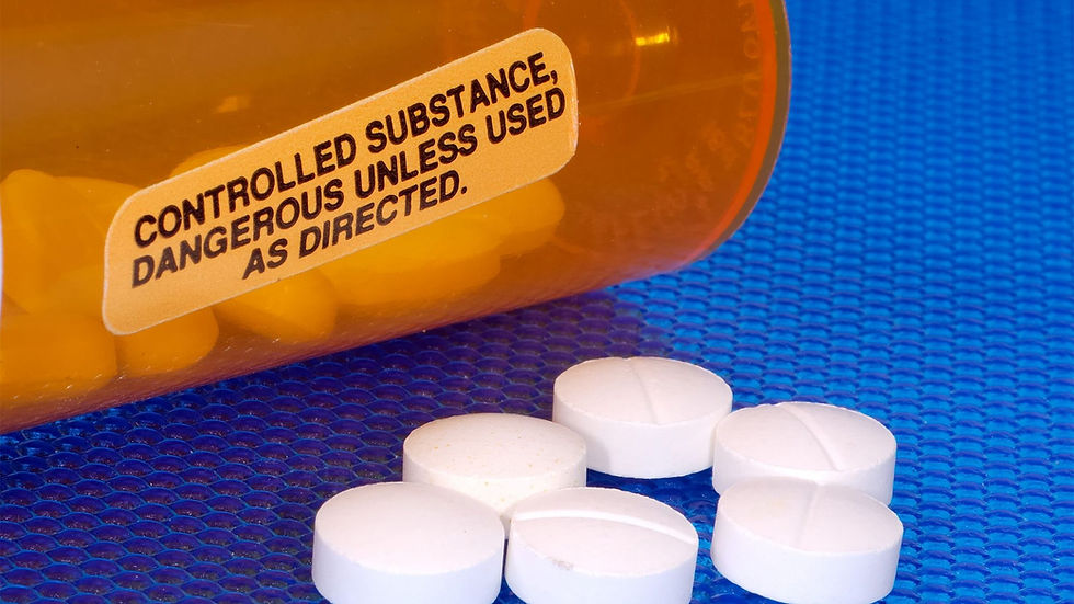 Pills on the table next to a controlled substance dangerous unless used as directed