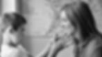 a black and white photo of a mother and child looking at each other with a map of the world on the wall behind them
